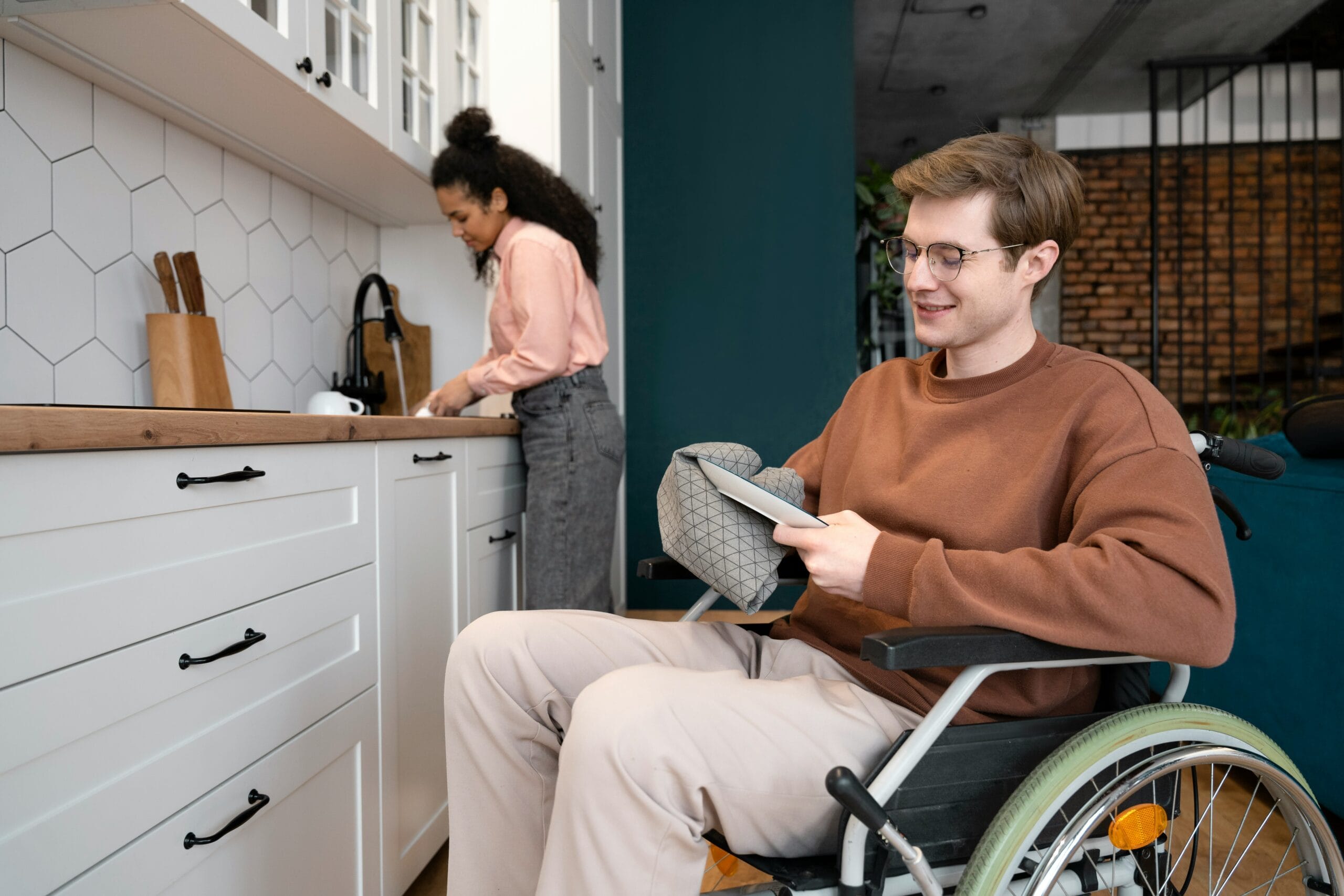 Person in wheelchair cleaning dishes